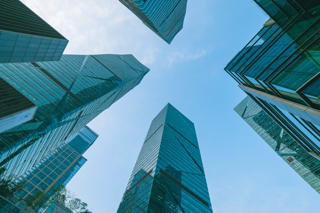services-03 Low angle view of contemporary skyscrapers in Shenzhen, China under a clear blue sky.