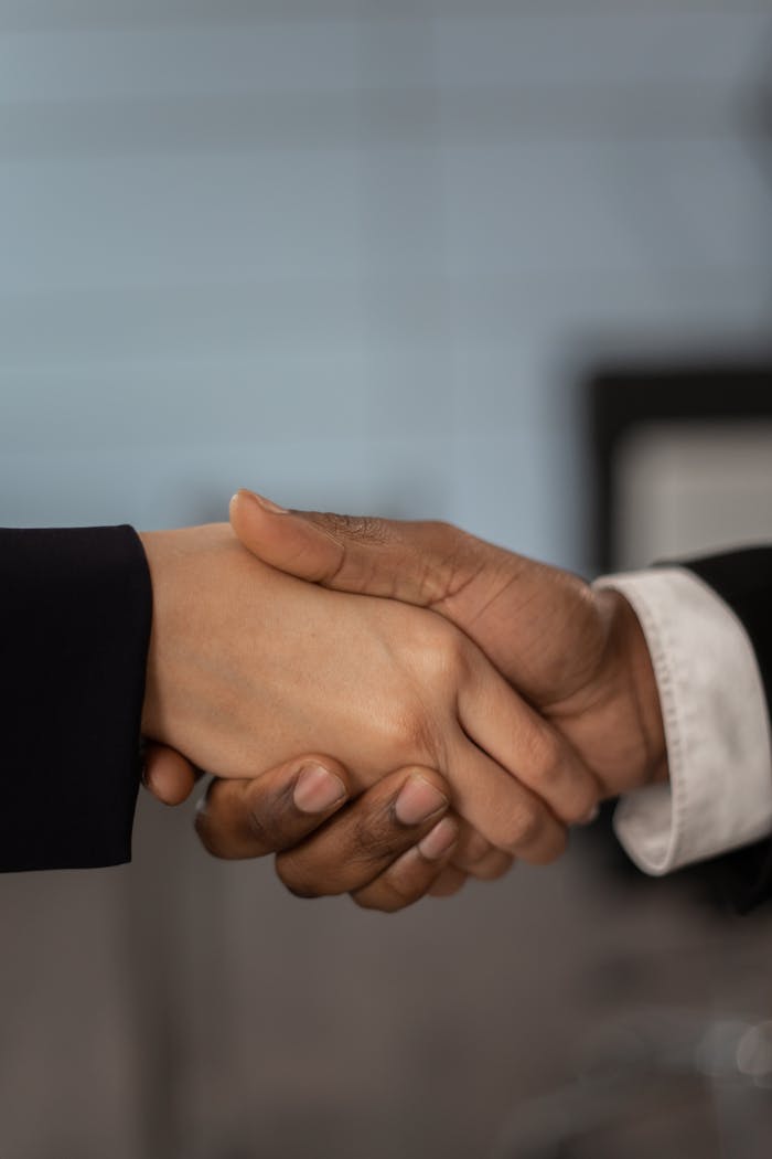why-choose-us Close-up of a professional handshake symbolizing business partnership and agreement.