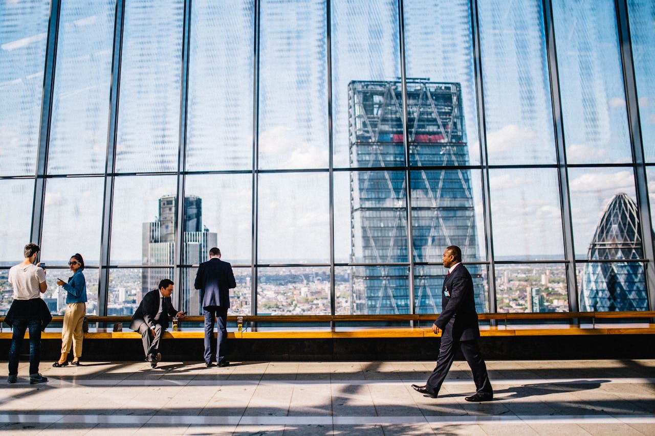 about-01 Business professionals in a modern office against a London skyline view.